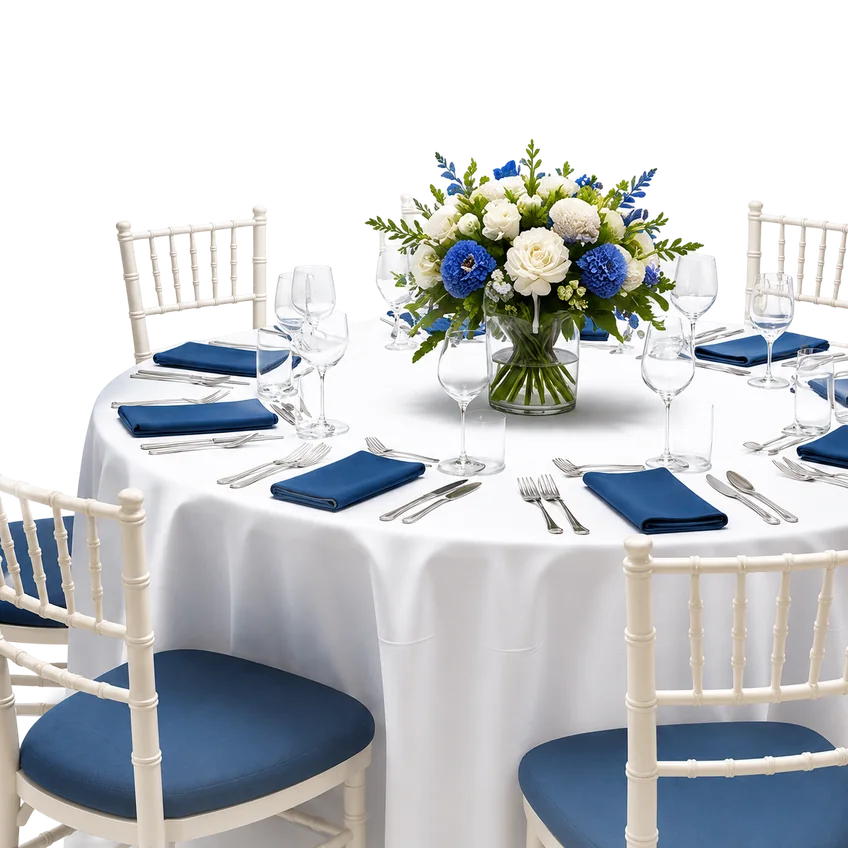 A banquet table laid for an event with a floral centrepiece