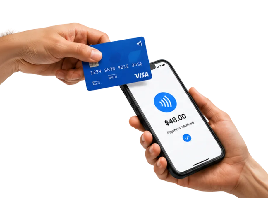 A hand tapping a bank card against a phone taking payment